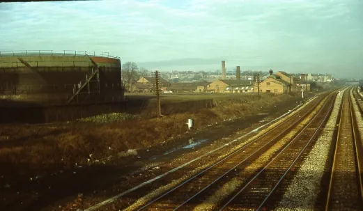The Midland main line at Langley Mill in the 1960s, looking from the Bridge Street to North Street footbridge, showing the gas tanks and the Pickersgill and Frost foundry.