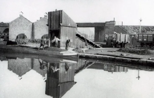 Coal being loaded onto a barge at Beggarlee Wharf, on the Cromford Canal, in the 1930s.