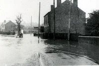 the impact of the Bailey Brook flooding, and they were both taken by the Midland General bus garage, on Station Road, at the bottom of Mansfield Road.